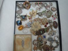 A tray containing a selection of costume jewellery brooches including mink, diamante, enamelled etc