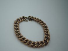 A rose metal curb chain bracelet stamped 9ct having a concealed box clasp, approx 20.4g