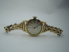 A vintage rolled gold wrist watch by Cyma having a baton numeral dial to small circular face on a
