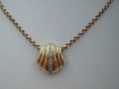 An American 14ct gold scallop shell pendant of moulded form having diamond chip decoration on a 14ct