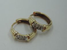 A pair of 9ct gold hinged hoop earrings having diamond chip panels, approx 3.2g