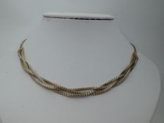 A 9ct two coloured gold articulated and plaited necklace, approx 26.4g
