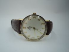 A gent's 9ct gold Omega automatic wrist watch having an Arabic numeral dial in plain gold case on