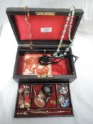 A vintage jewellery box containing a small selection of vintage and modern costume jewellery