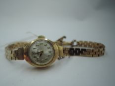 A lady's 9ct gold gold Roamer wrist watch having an Arabic numeral dial to small face in gold case