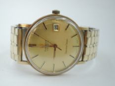 A gent's yellow metal Tissot Visodate Seastar Seven wrist watch having baton numeral dial with