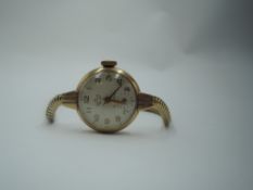 A 9ct gold vintage wrist watch by Smiths having Arabic numeral dial with subsidiary seconds on a 9ct
