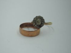 A 9ct rose gold wedding band, size P and a paste daisy cluster dress ring in a white metal mount