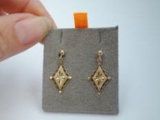 A pair of yellow metal stud earrings having antique style diamond shaped drops, no marks, approx 2g