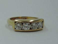 A four stone diamond dress ring, total approx 1ct in a parallel collared mount on an 18ct gold loop,
