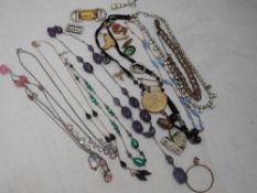 A selection of vintage costume jewellery including necklaces, charms, brooches etc