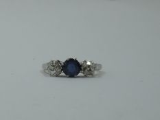 A lady's old cut sapphire and diamond three stone ring, sapphire approx .75ct and total diamonds
