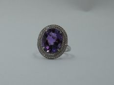 An oval facet cut heat treated amethyst ring having a diamond chip double border in a pave setting