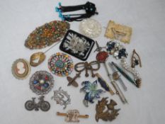A selection of costume brooches including souvenir, golf interest, enamelled etc