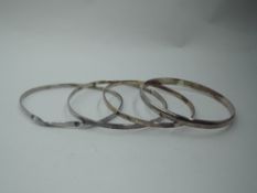 Four HM silver bangles of plain form, approx 44.3g