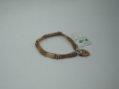 A 9ct rose gold three bar gate bracelet having padlock clasp, approx 7.5g