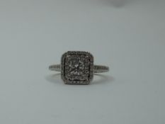 A princess cut diamond, approx 0.5ct ring in a diamond set halo surround to diamond set shoulders on