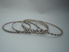 Four HM silver slave bangles of twist form, approx 51.5g