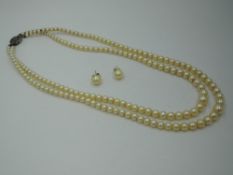 A double row of graduated cultured pearls having a silver box clasp with marcasite decoration,