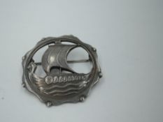 A Danish silver brooch of circular form depicting a Viking Ship by Carl Ove Frydensberg