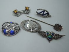 A small selection of white metal and silver brooches including enamelled Wings brooch stamped