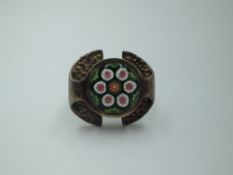 A silver ring by Caithness glass having a millefiori glass panel in a stylised mount, maker CJ, size