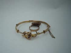 Three pieces of damaged 9ct gold jewellery including wedding band, hinged bangle with knot