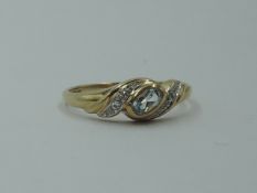 An aquamarine set dress ring with diamond chip set swirl shoulders on a 9ct gold loop, size M &