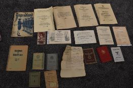 A folder containing German WW2 Period documents, Hitler Youth Magazine, Identity Books, Music Book