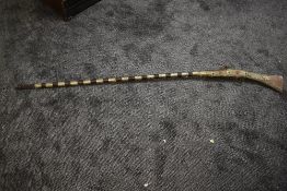 A possibe 19th century Indian Long Gun (af) having decorated brass decoration, overall length 154cm