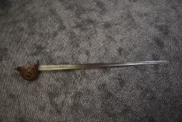A possible 18th century Scotish Broadsword having steel basket handle with carved wood grip, blade