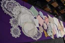 An assortment of vintage table linen, some embroidered items,linen examples included.