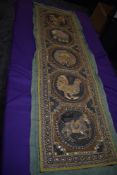 An unusual antique Indian or similar wall panel having raised animals to centres of circular