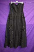 A 1950s black strapless dress with sequin detailing,back metal zipper and 'lady in black' label, a