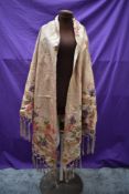 A beautiful antique silk shawl having bright floral design and deep fringed edge, very fragile but