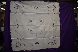 A vintage linen table cloth and napkins with cut work and embroidery.
