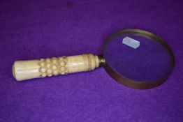 A vintage brass framed spy glass having carved bone handle