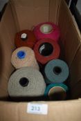 A selection of large cotton or wool reels for textile or weaving work