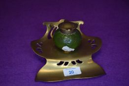 An art nouveau copper and green glass ink well marked Ges Gesch