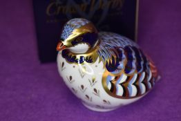A ceramic Royal Crown Derby paper weight or figure of a Red Leg Partridge having gold stopper and