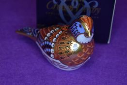 A ceramic Royal Crown Derby paper weight or figure of a Linnet having gold stopper and box