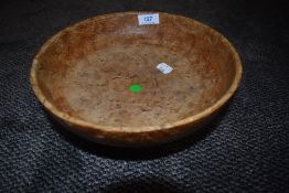 A hand turned footed fruit bowl in a burr wood