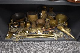 A selection of brass wares including fire side items and decorated planter