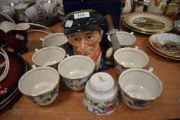 A selection of tea cups by Royal Doulton in the Booths design and a character jug Little Mester