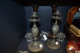 A set of well cast pewter candle sticks and similar oak twist pair