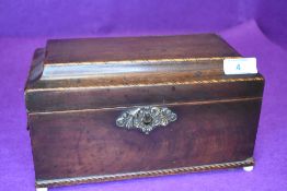 A Victorian tea caddy having mahogany case and inlaid banding with double compartment