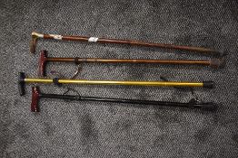 Four walking canes or sticks including adjustable and horn handle