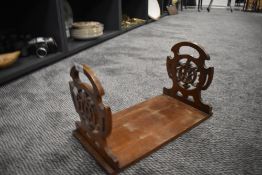 A vintage book shelf or rack having gothic fret work ends