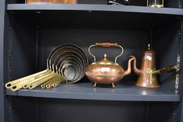 A fine set of graduated copper and brass handled pans with a similar chocolate pot and kettle