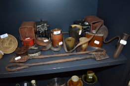 A selection of hardware including animal horn beakers, black smith tools and block and tackle hook